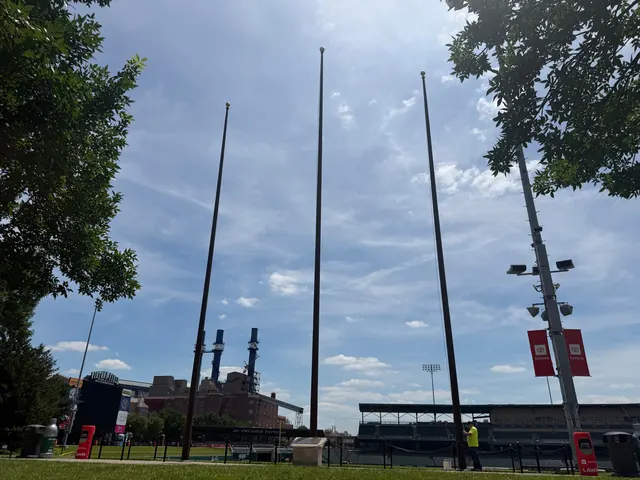 Multiple pole set at a ballpark.