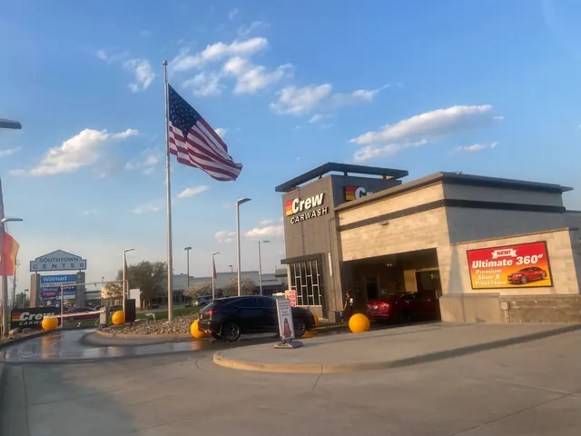Commercial pole and flag set at a Crew Carwash location.