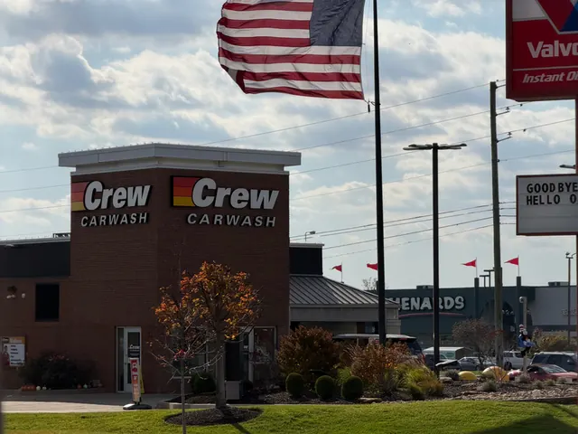 Storefront flags flying at a Crew Carwash location.