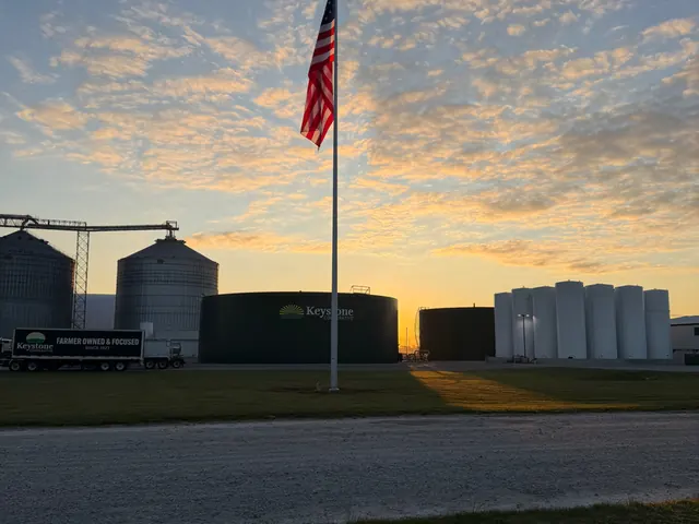 Pole flying over a grain elevator at sundown in west-central Indiana.