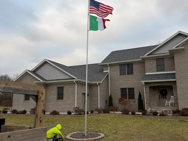 Off Duty Flagpoles crew member installing a residential flagpole at an Indiana home