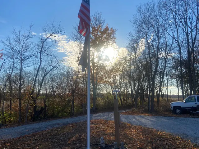 Flagpole standing on a cleared Indiana lot ready for removal