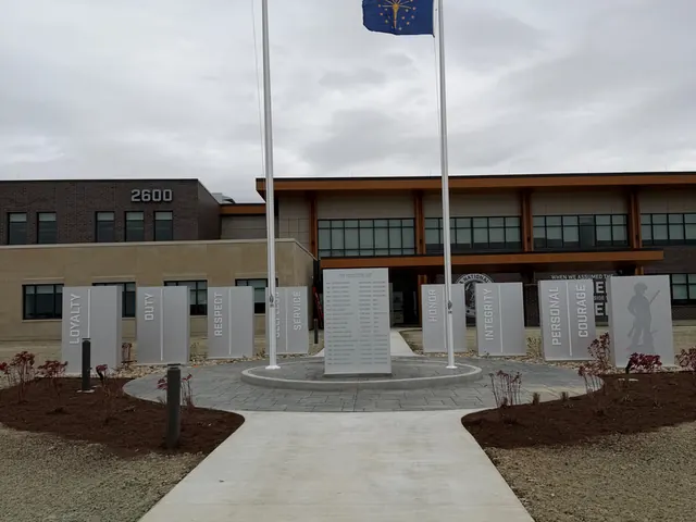Memorial plaza pole set alongside engraved veteran panels.