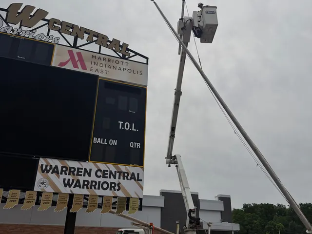 Bucket truck work beside the scoreboard on the east side of Indianapolis.